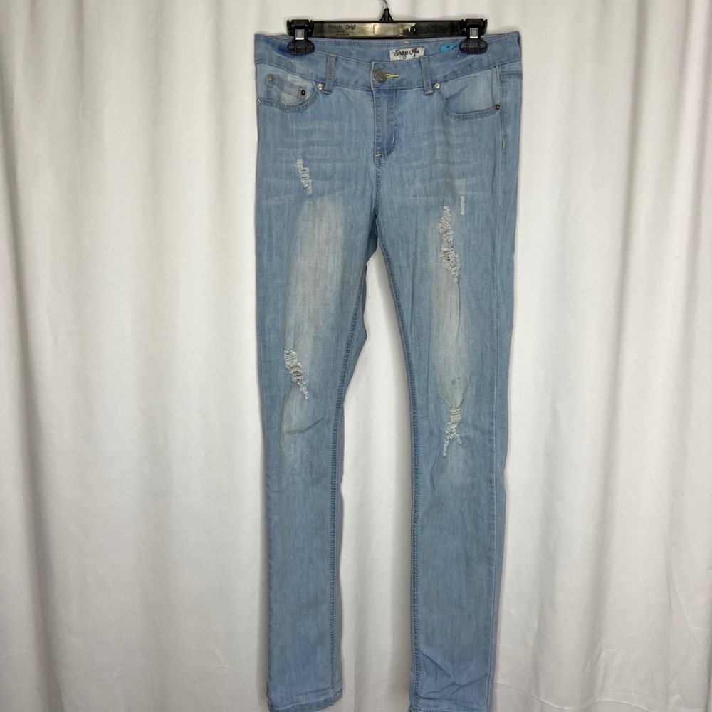 Distressed skinny blue jeans